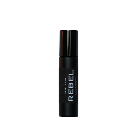 A black rollerball perfume bottle with the word 'REBEL' printed on it.