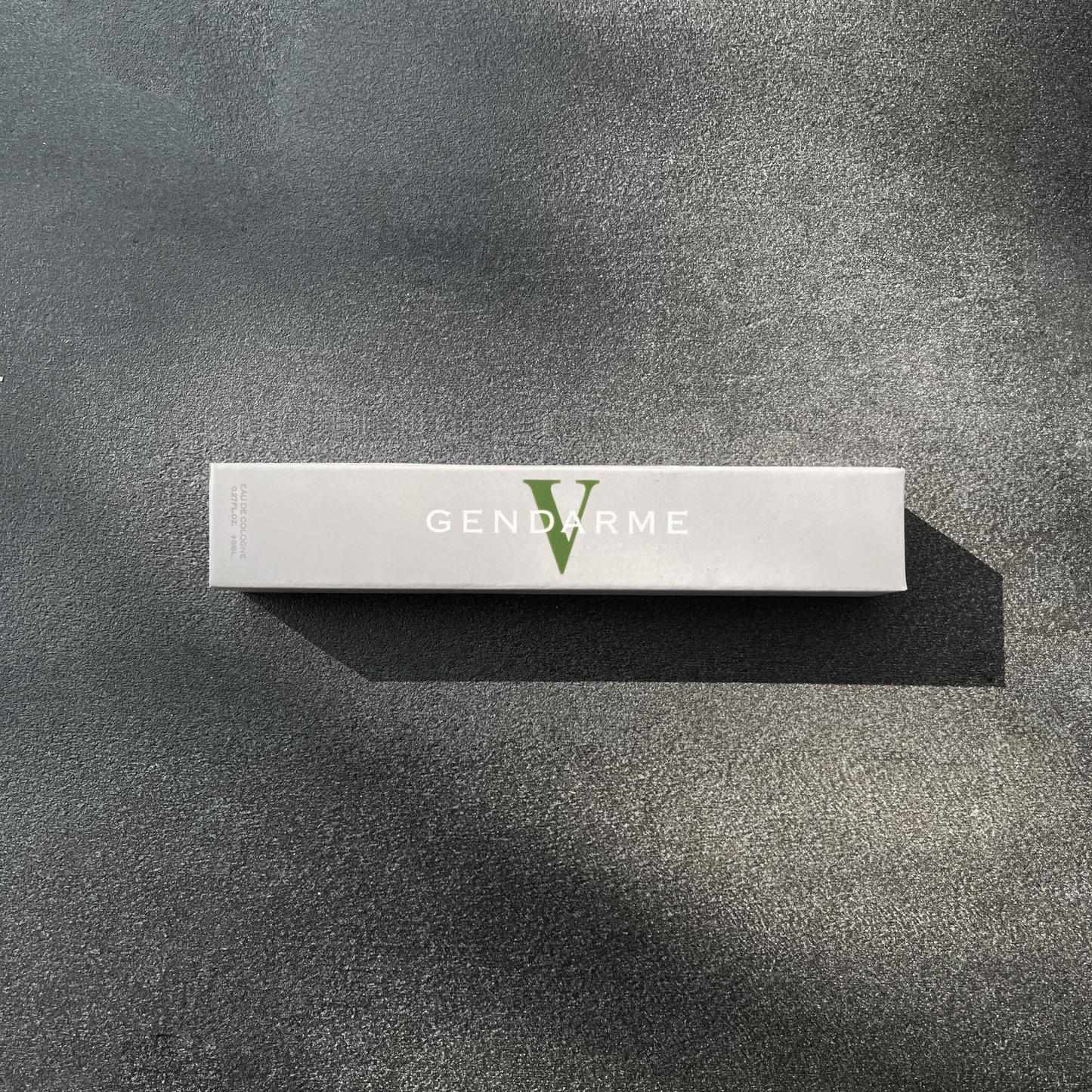 Decorative Image of Grey box on granite background. Box includes logo in white and green "Gendarme V'